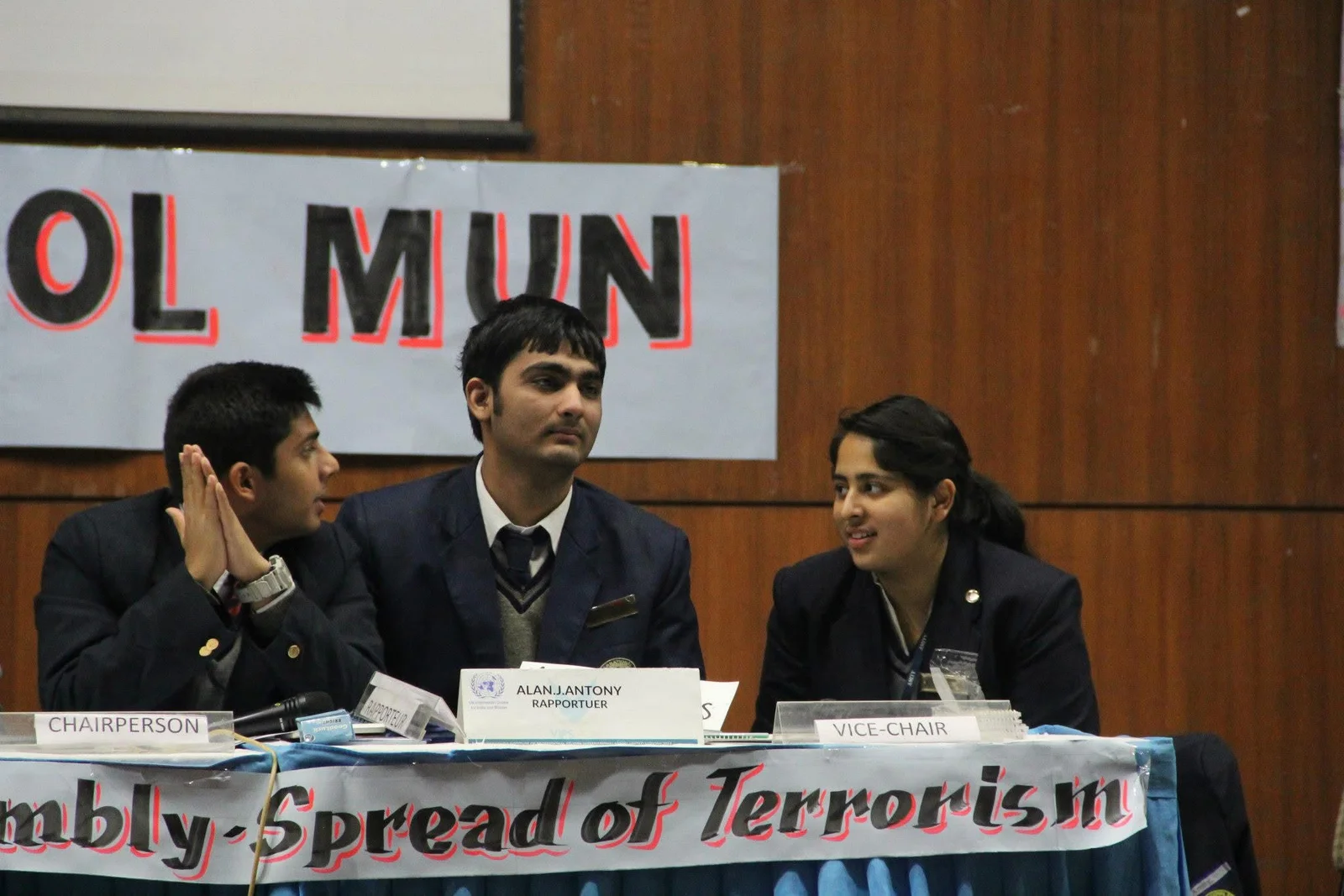A school Model United Nations panel seated behind committee placards.